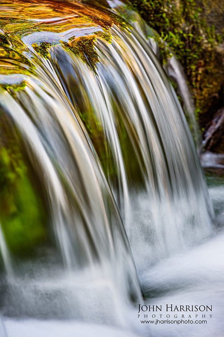 Close-up of Fern Spring waterfall in Yosemite Valley, silky water flowing over moss-covered rocks in winter light, a small hidden roadside waterfall and quiet photo stop in Yosemite National Park