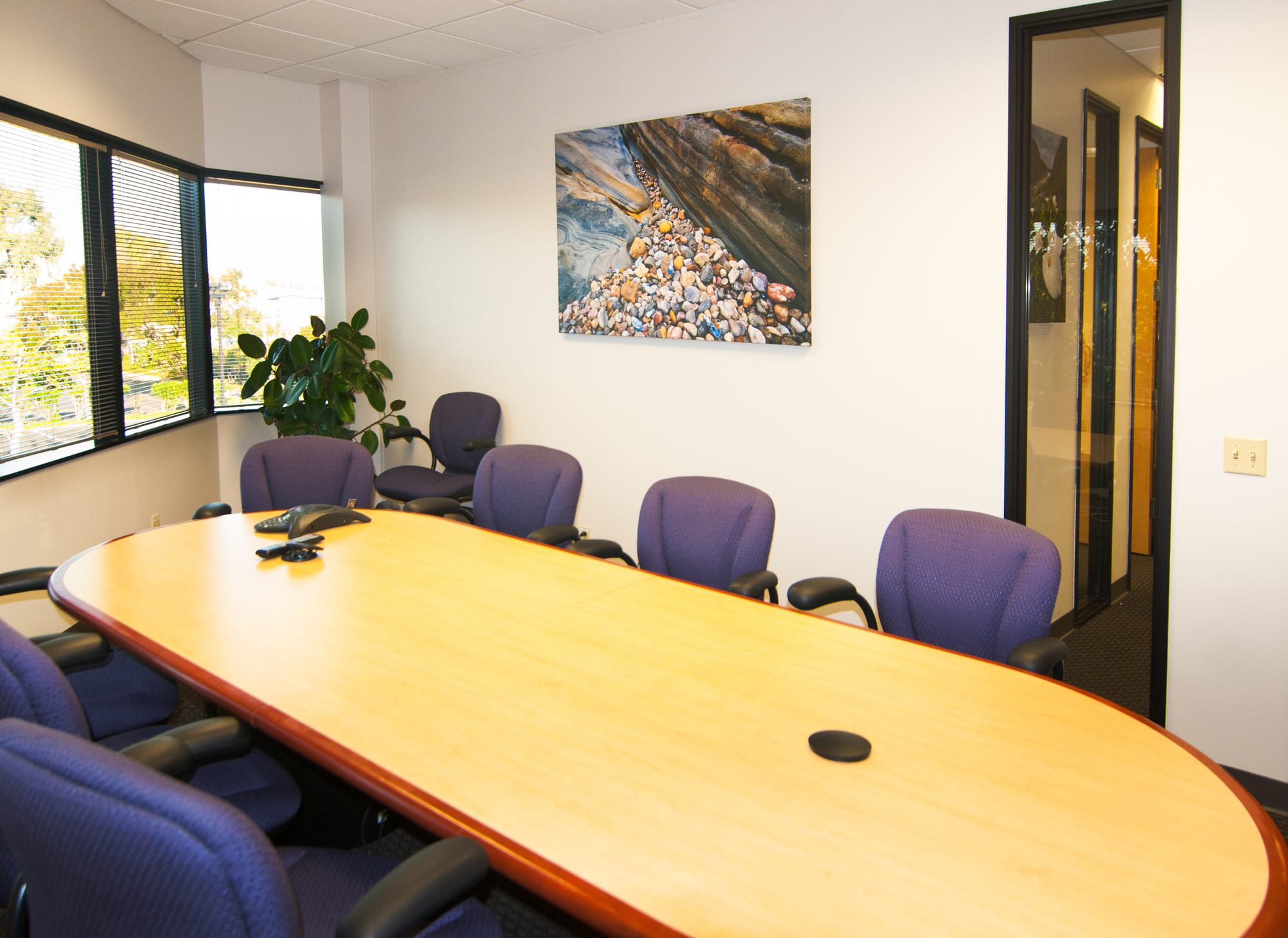 Abstract fine art photo of smooth coastal pebbles flowing between sculpted rock formations at Point Lobos State Natural Reserve near Carmel-by-the-Sea, California along the Big Sur coast.
