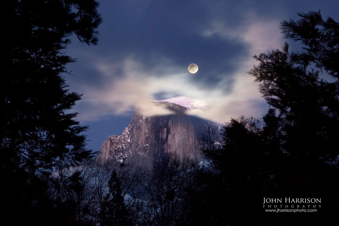 Full moon rising above Half Dome in winter, Yosemite National Park, framed by clouds and pine trees — fine art landscape photography by John Harrison