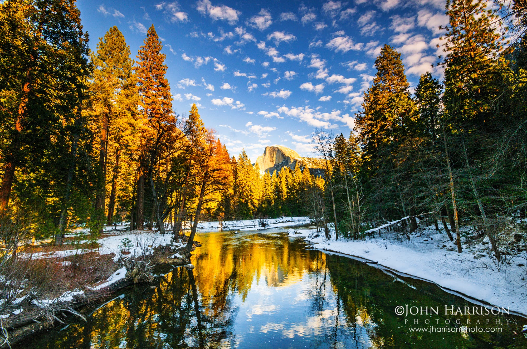 Yosemite Winter Itinerary: Half Dome reflecting in the calm Merced River with fresh snow and morning light.