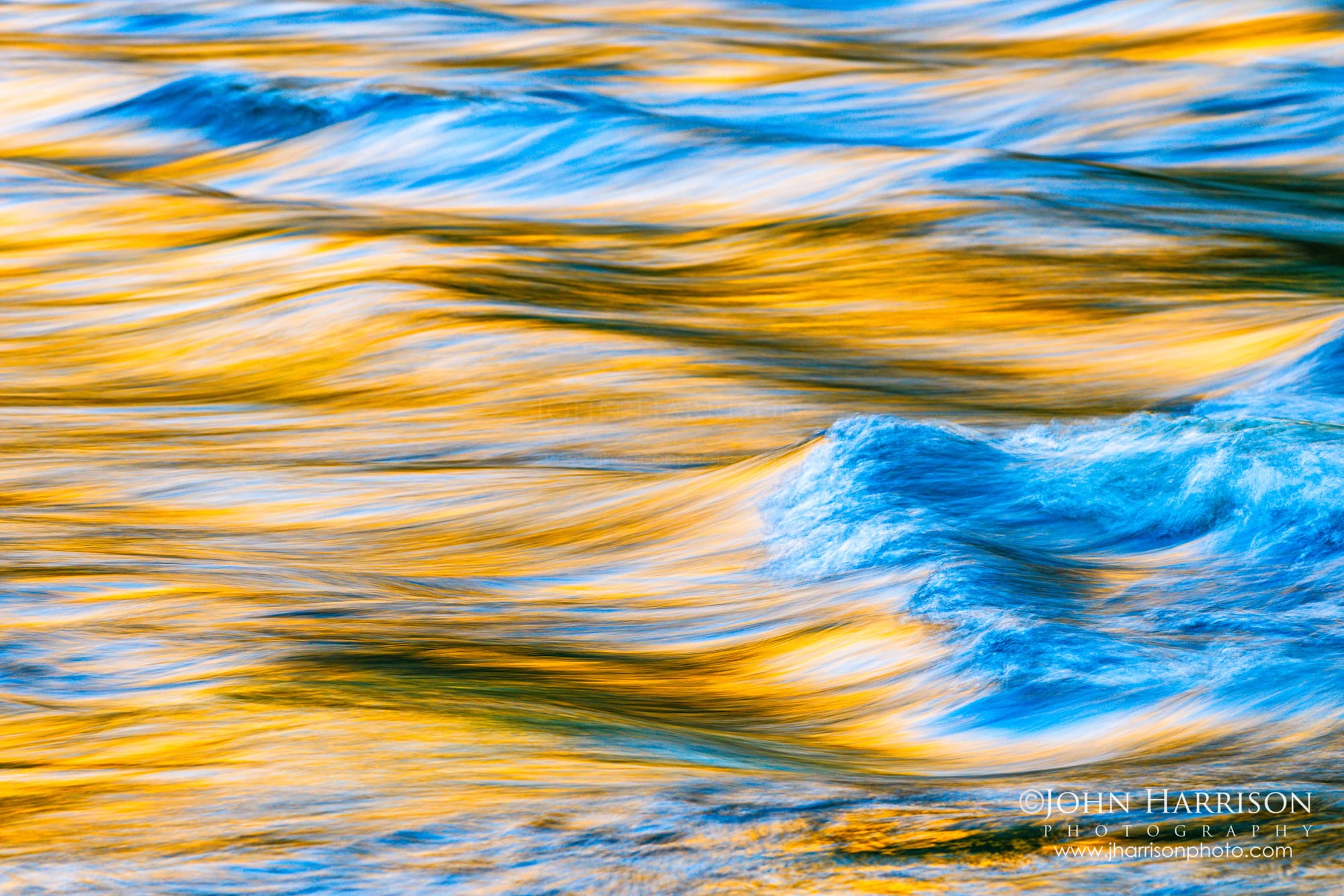 Fine Art Photograph of an abstract long exposure water texture in the Merced River with warm gold and cool blue tones, Yosemite National Park