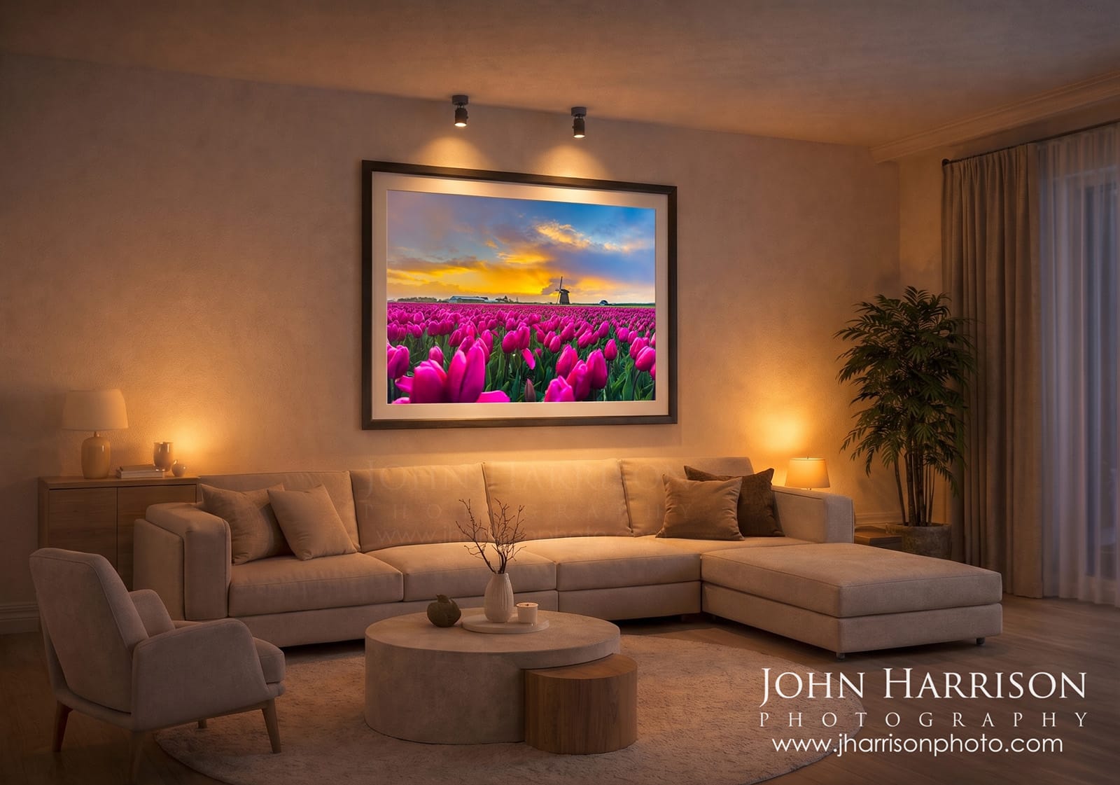 Large framed photograph of Dutch tulip fields and windmill at sunset displayed in a modern living room with warm lighting