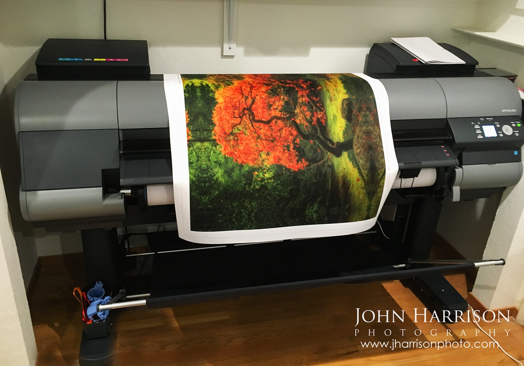 Fine art landscape photographer John Harrison producing a museum-quality Japanese maple print on a large-format Canon fine art printer during the archival printmaking process.
