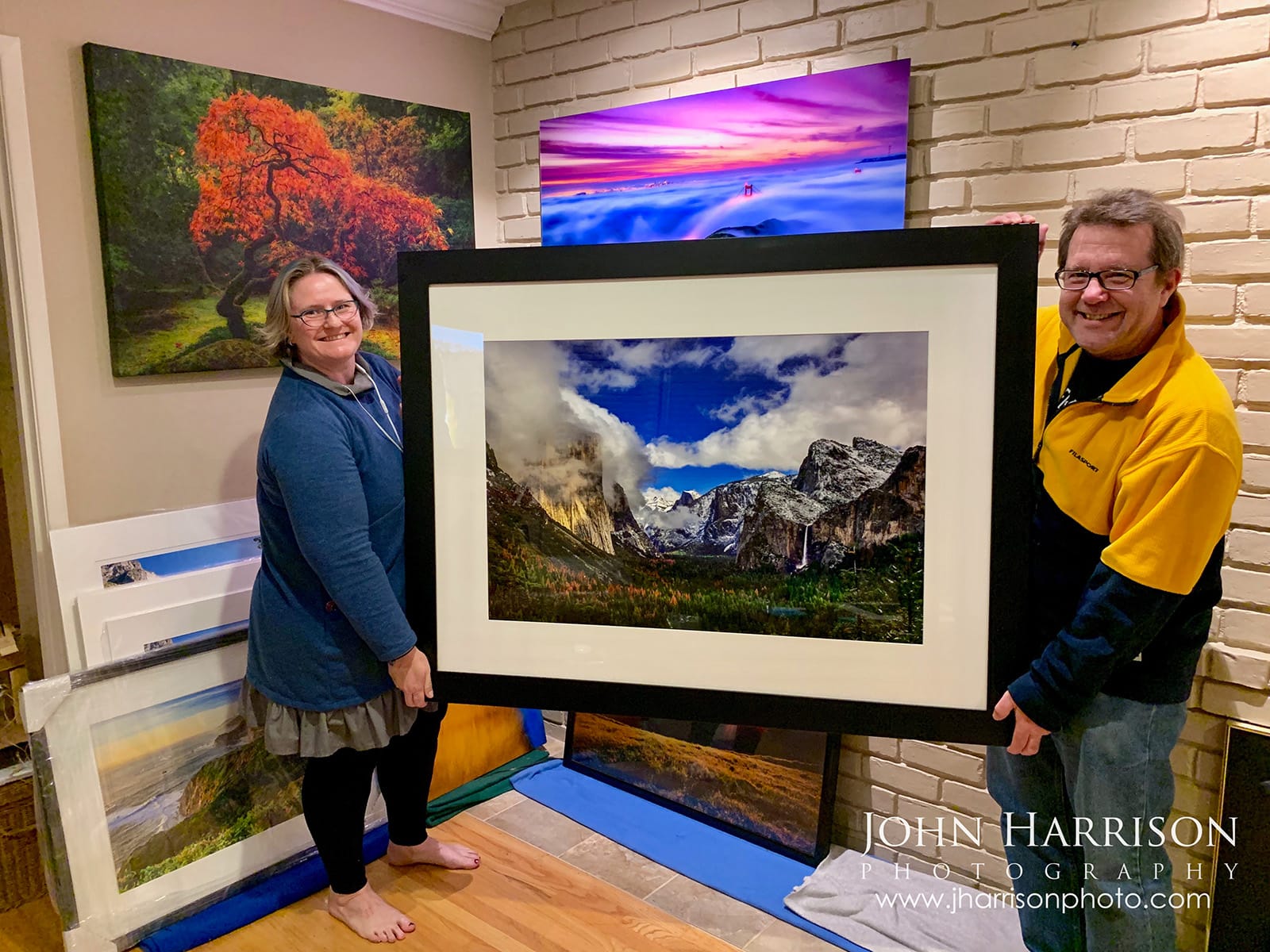 Collectors holding framed Yosemite Tunnel View winter wall art print featuring El Capitan and Half Dome.