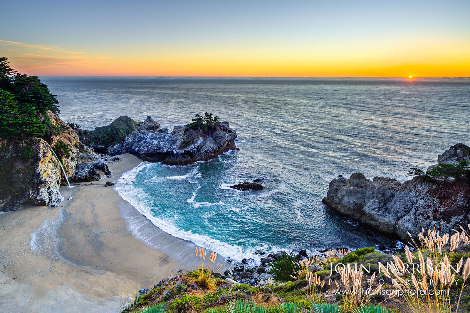 McWay Falls at sunset in Big Sur California with waterfall flowing into a turquoise cove along the Pacific Ocean in Julia Pfeiffer Burns State Park
