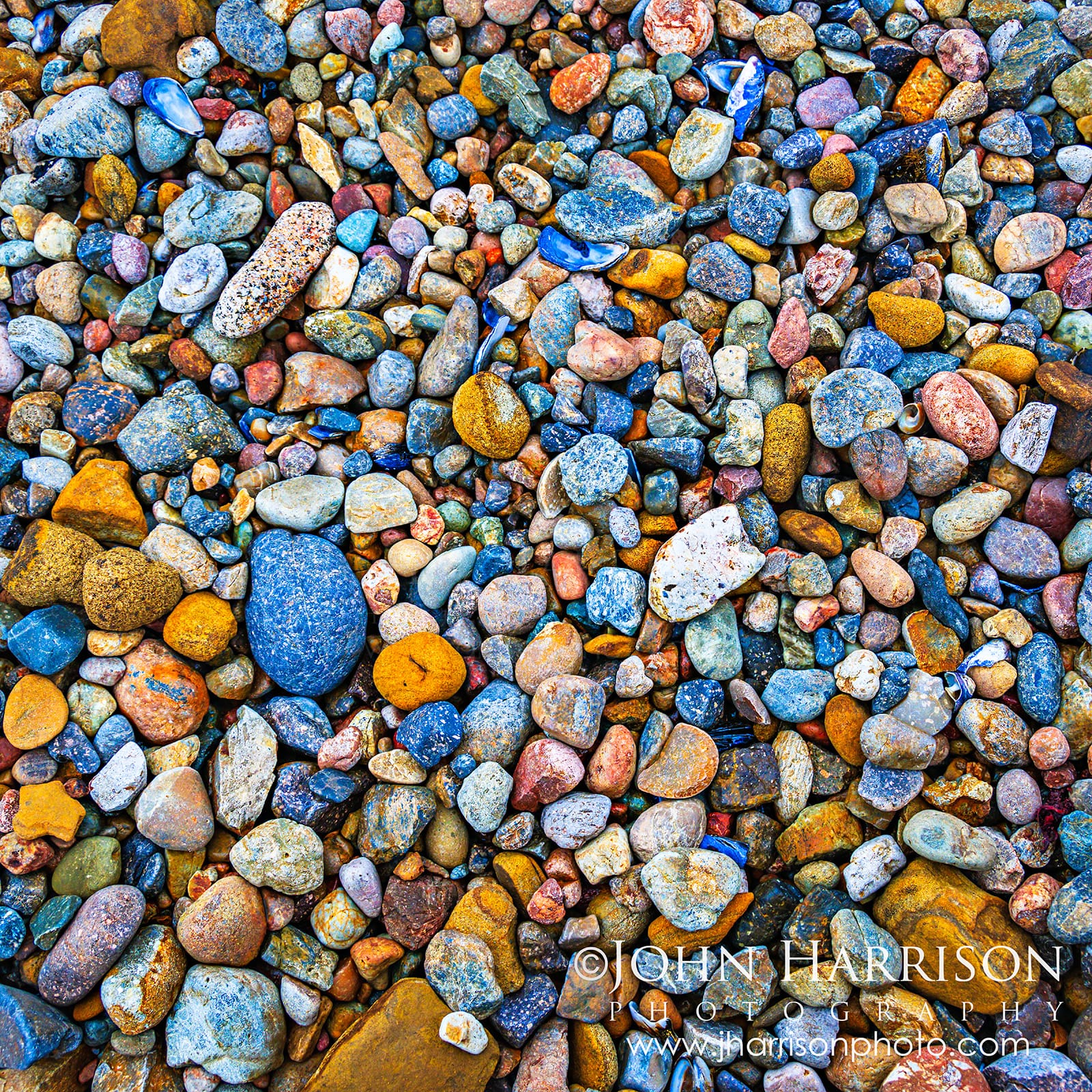 Colorful wave-polished pebbles covering Weston Beach at Point Lobos State Natural Reserve, California.