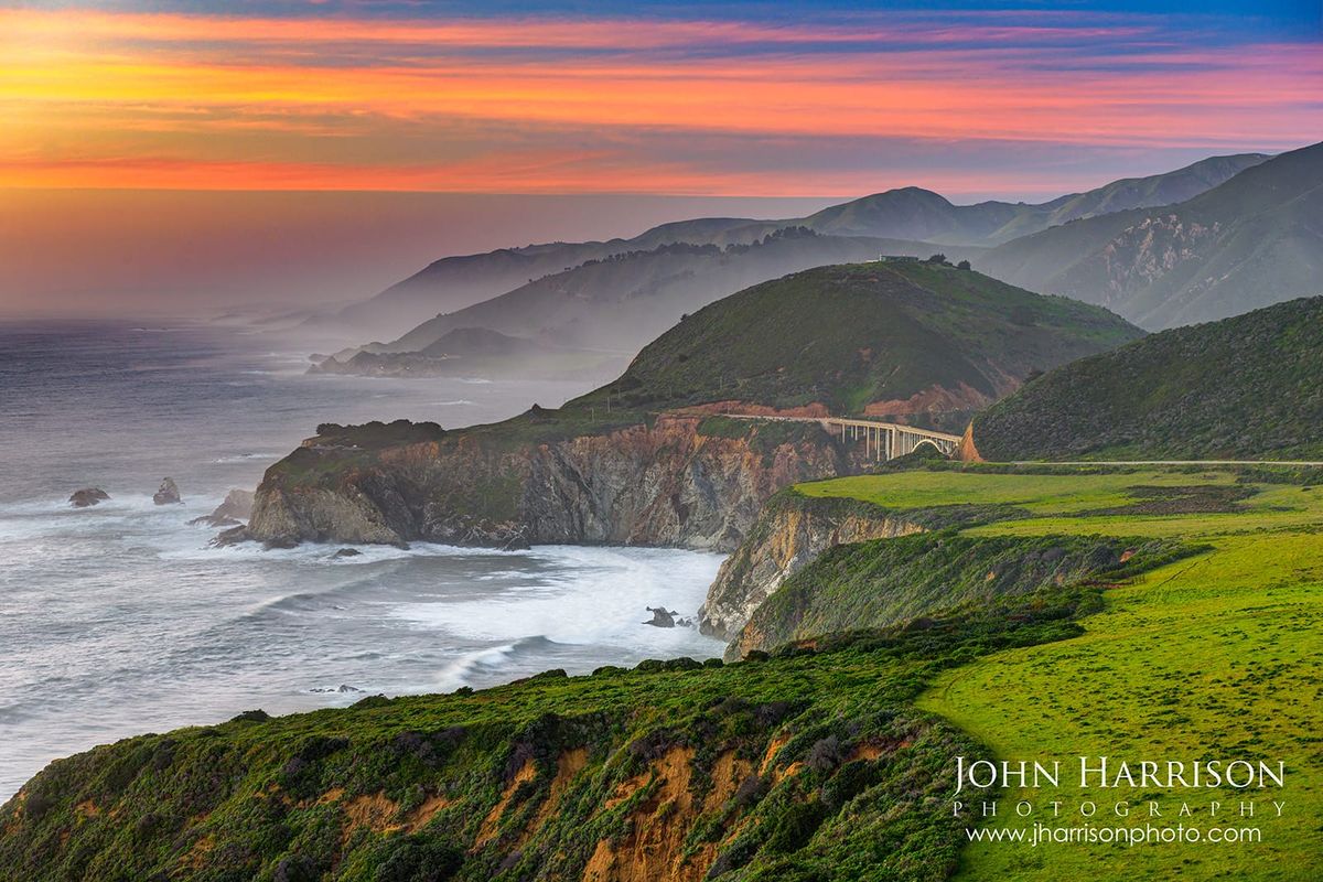 Bixby Bridge at sunset in Big Sur, California, surrounded by colorful skies, coastal fog, dramatic cliffs, and panoramic Pacific Ocean views along Highway 1.