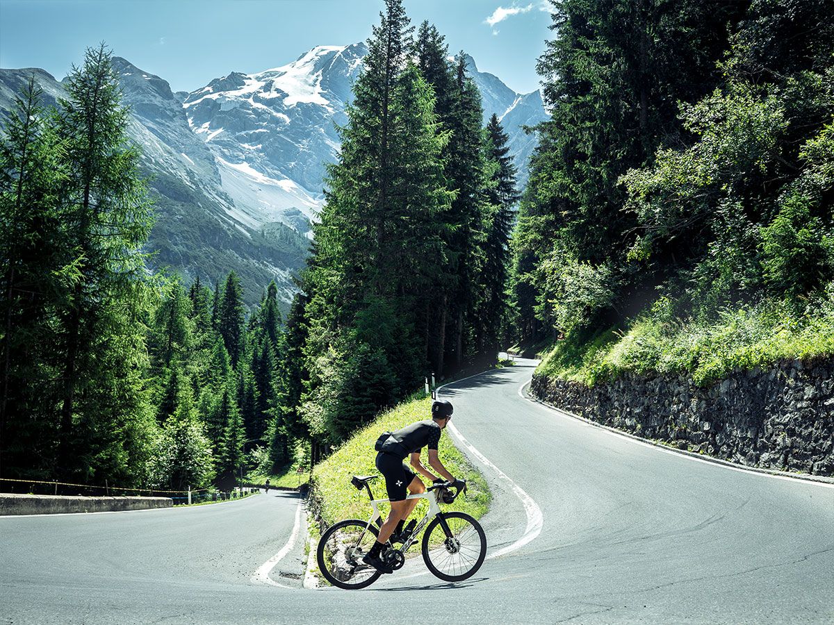 Cyclist riding one of the 48 hairpins of the Stelvio Pass
