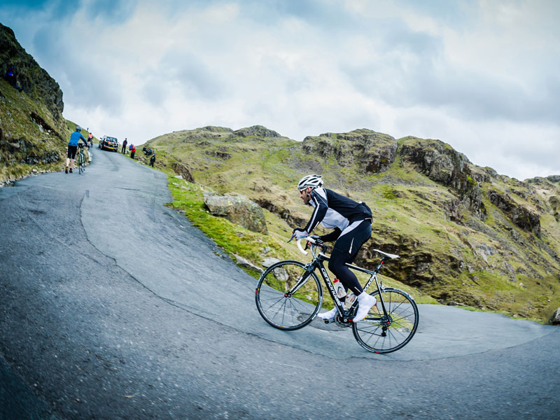 Cyclist riding up mountain