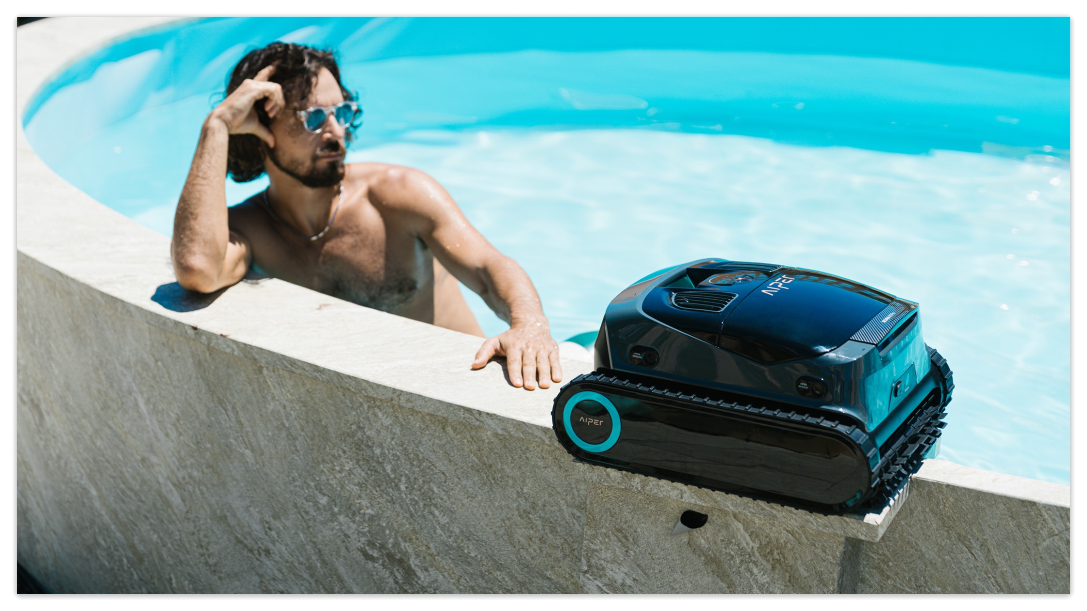 A man enjoys swimming with a robotic cleaner in responsible for pool cleaning.