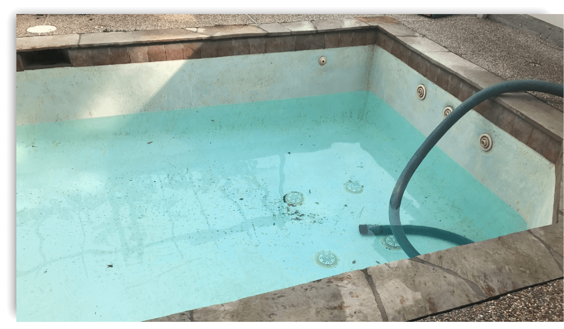 Partially drained swimming pool with hose - Efficient Pool Draining