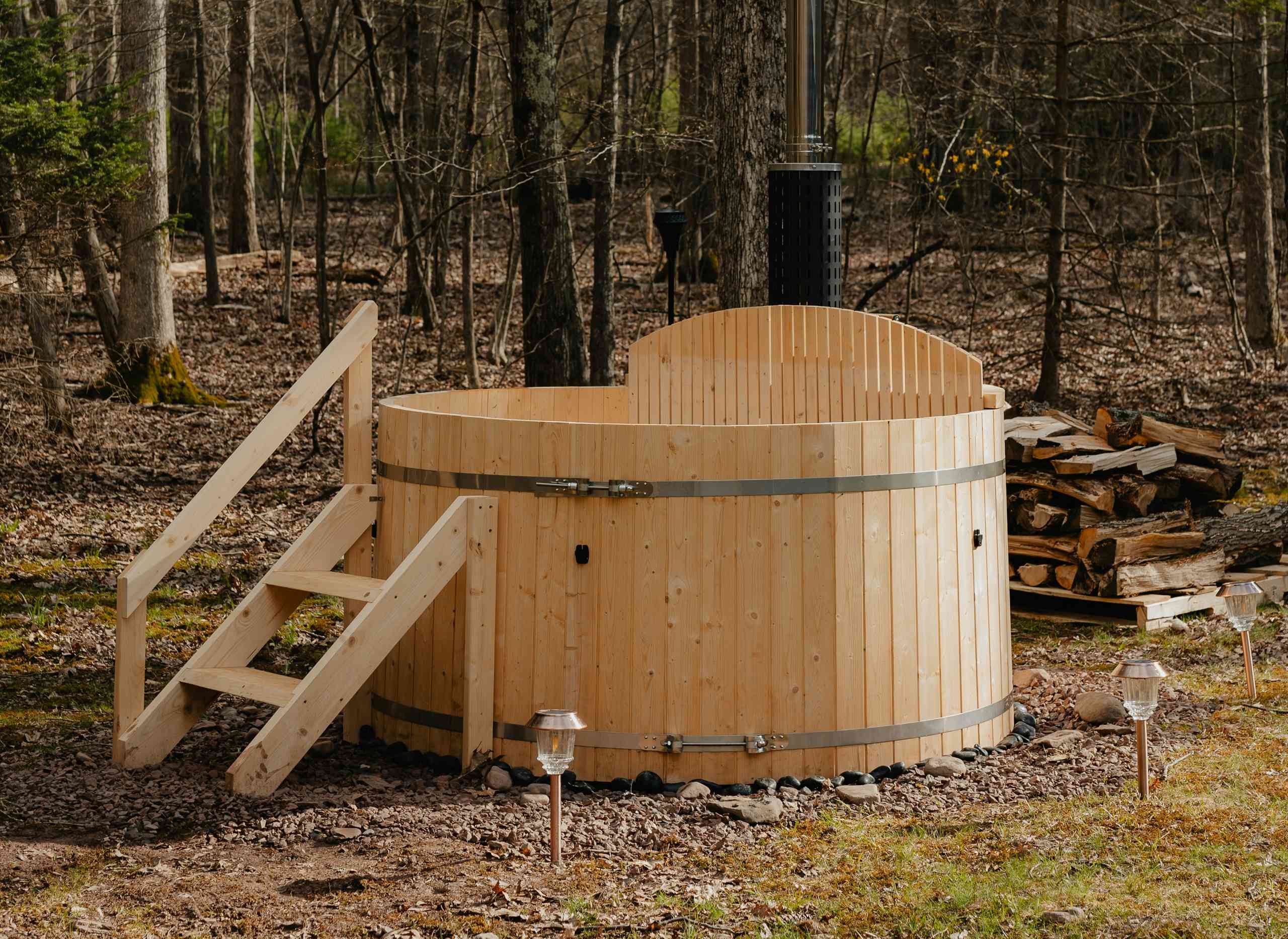 Wooden hot tub with stairs.