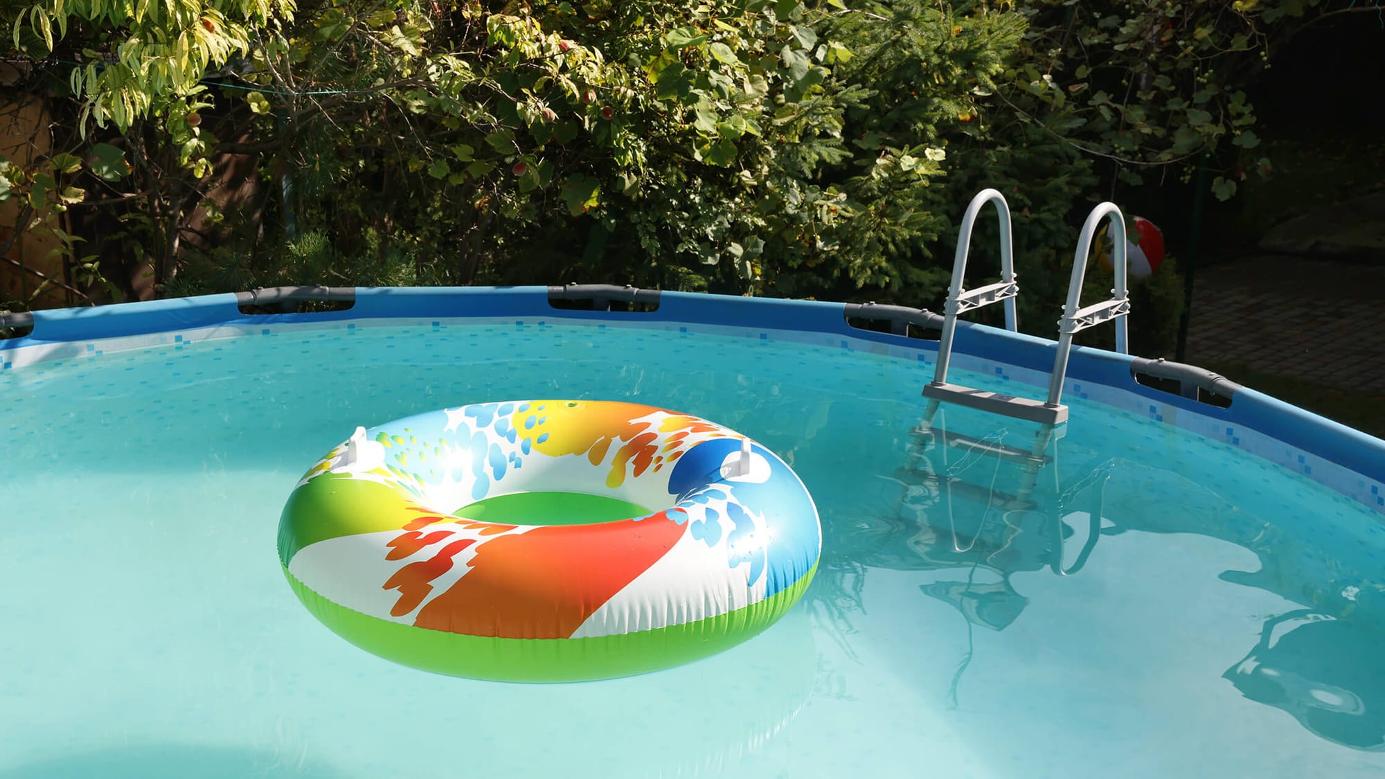 A life buoy floats on the surface of the Intex swimming pool