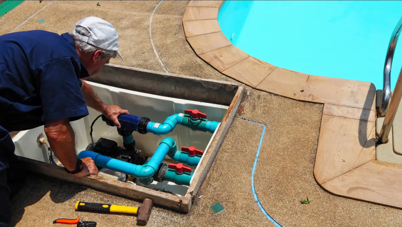 A man checking a pool pump.