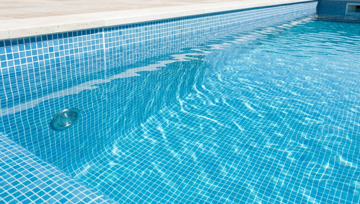 Spotless clean pool floor and wall with balanced water chemistry and regular physical cleaning.