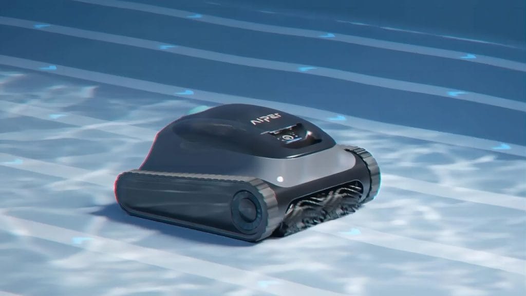 A robotic pool cleaner cleaning the bottom of a sparkling blue swimming pool