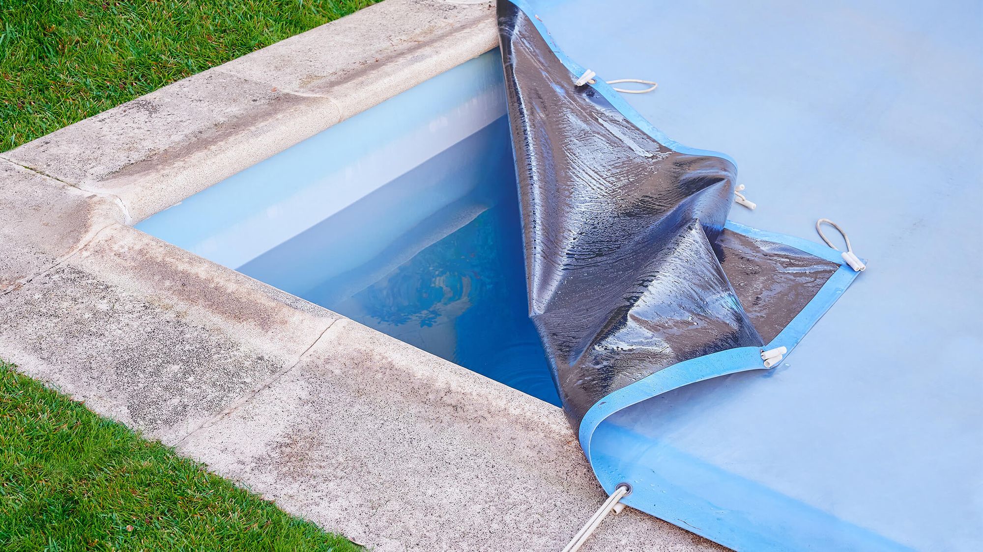 A corner of the swimming pool cover was lifted