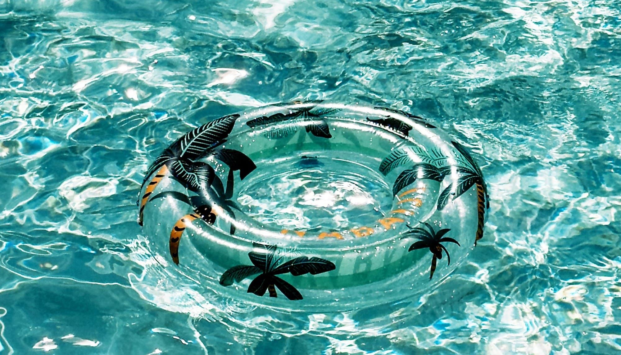 A swimming ring is floating on the clear pool