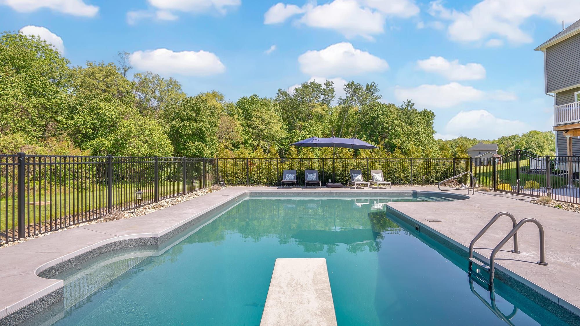 a residential pool on a sunny day, illustrating the area for effective night-time shock treatment.