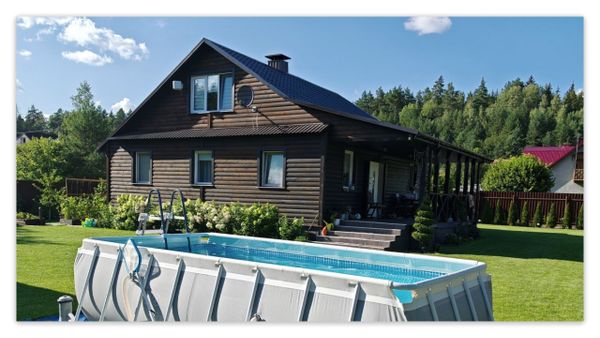 An installed above-ground swimming pool is set in a backyard next to a wooden house in Australia.