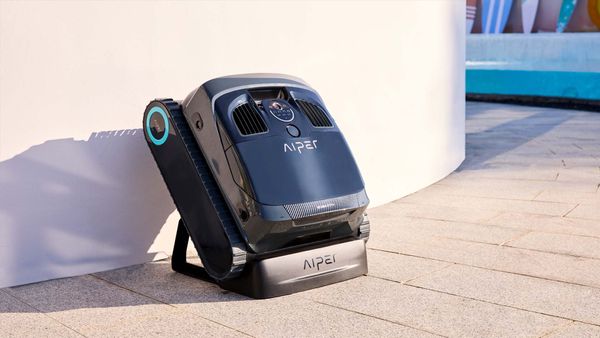 A robotic pool cleaner is placed in the corner of the pool.