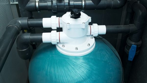 A close-up of the top of a pool pump.