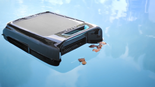 A robotic pool skimmer removes leaves from the pool surface