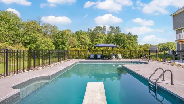 a residential pool on a sunny day, illustrating the area for effective night-time shock treatment.