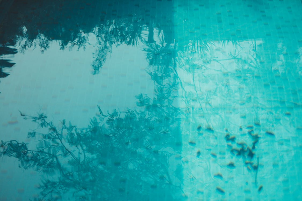 Outdoor swimming pool surface with dirt and debris