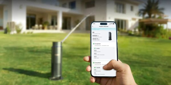 a homeowner is controlling the smart sprinkler with app