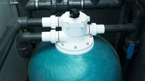 pool filter tank with plumbing connections for pump priming issues.