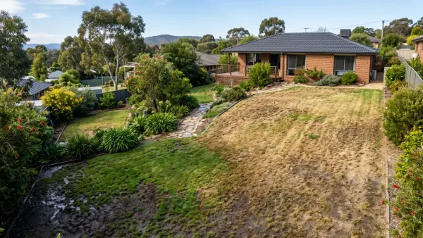 Sloped lawn in Australia showing dry top and waterlogged bottom after watering.