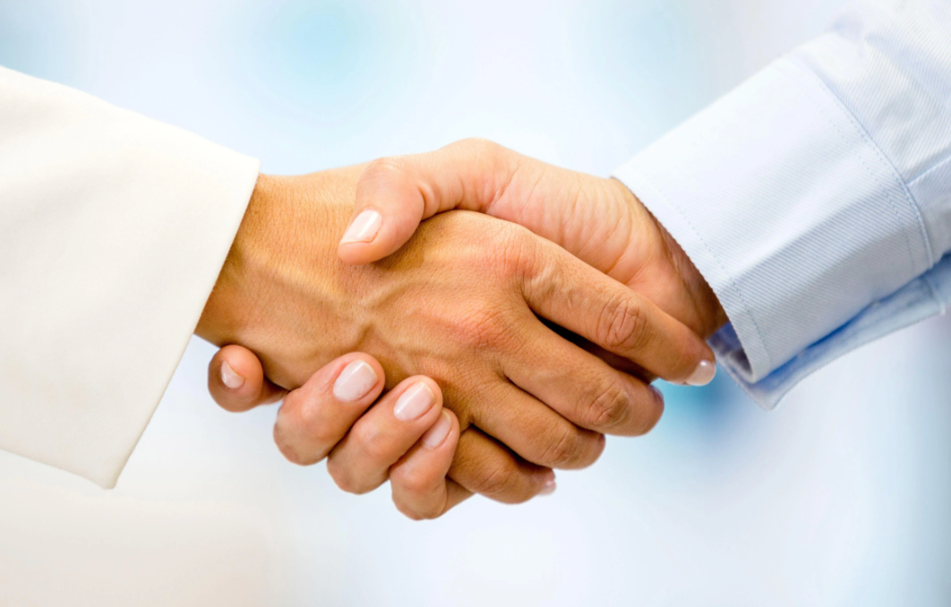 image of two people shaking hands