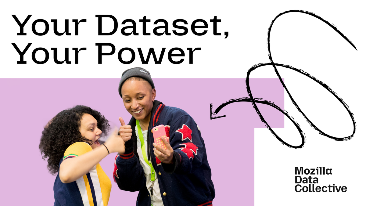 Image shows two people giving a thumbs up sign in front of a mobile phone.