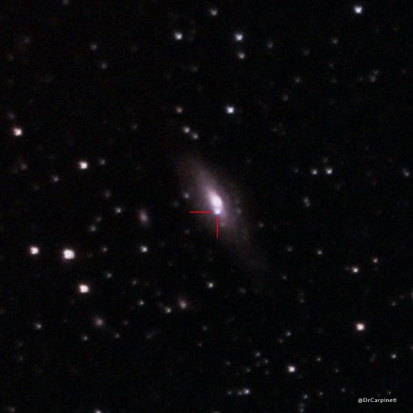A spiral galaxy is in view in the middle of the image and a bright dot is seen right south of center