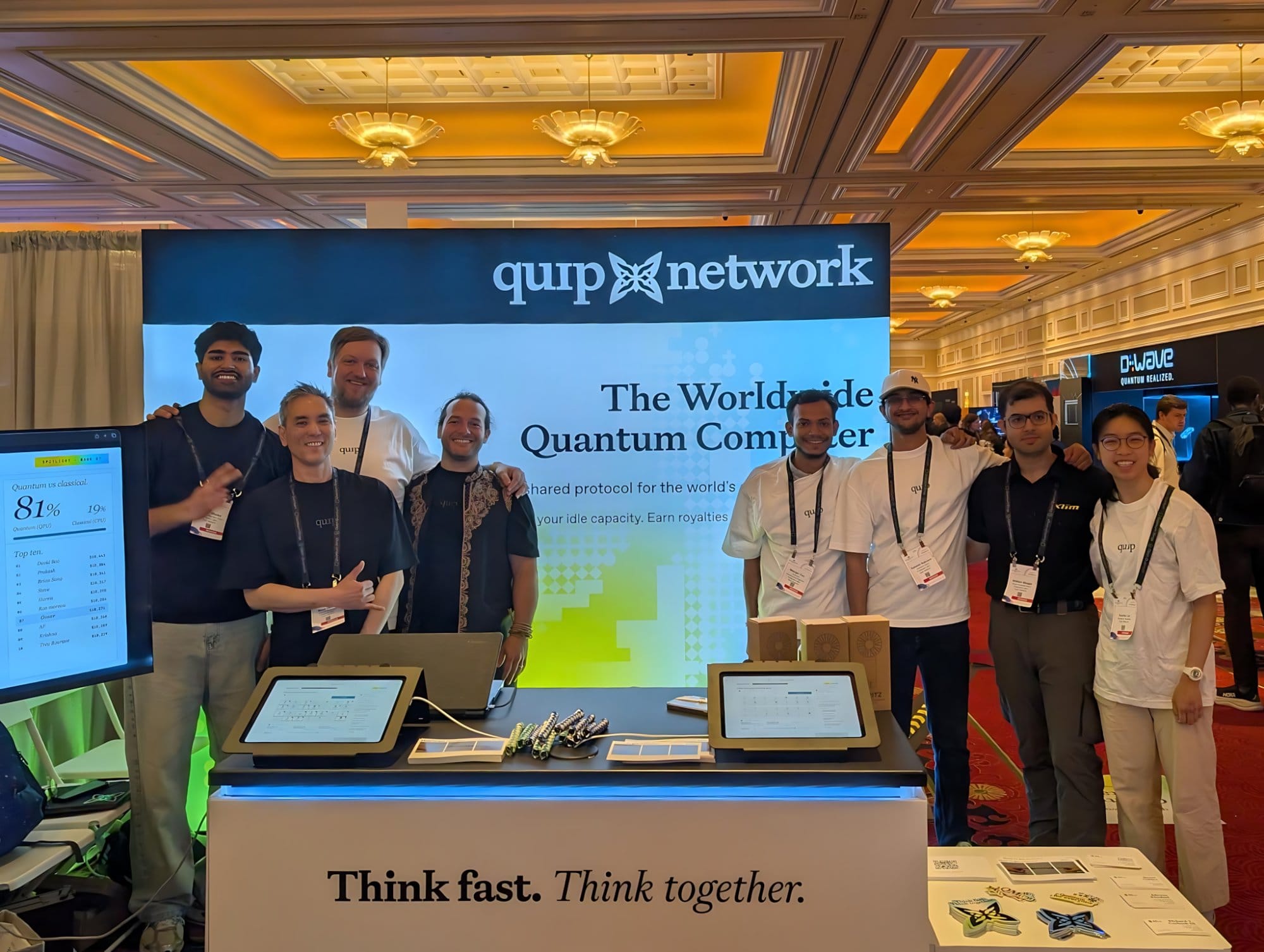 The Quip Network team standing together in front of the booth backdrop.