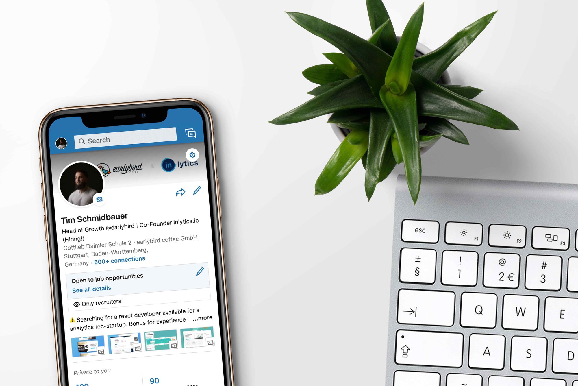 A mobile device with the LinkedIn app open, and a keyboard.