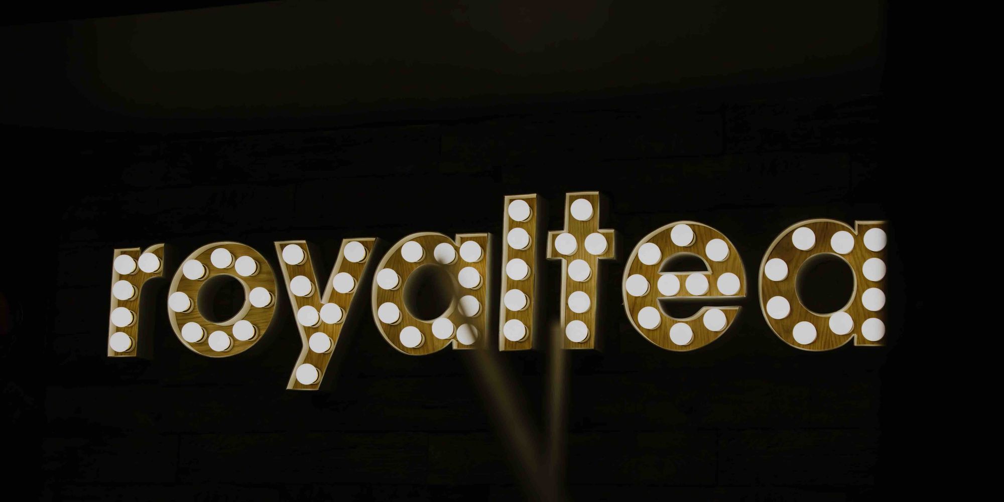 The word 'royaltea' on a black background.