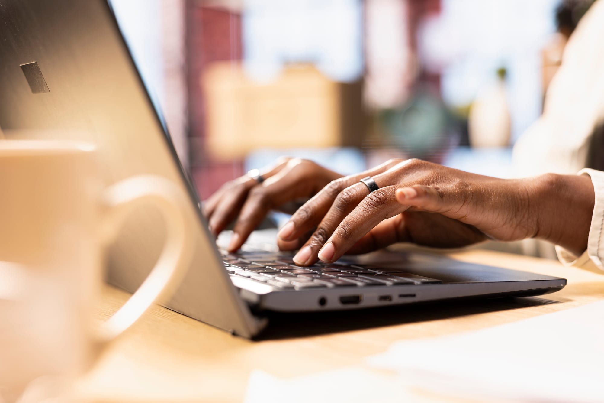 Close up of female hands typing on a laptop.