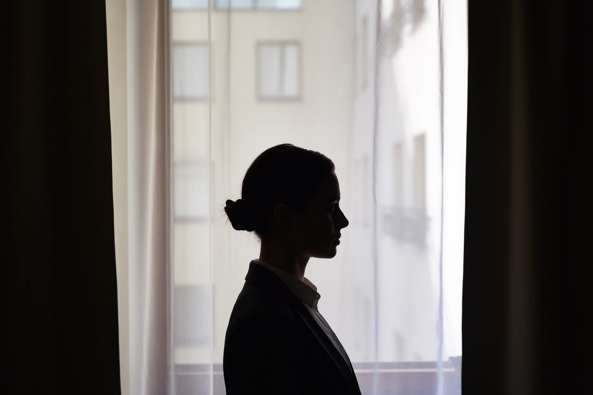 Silhouette Of Businesswoman In front of window.