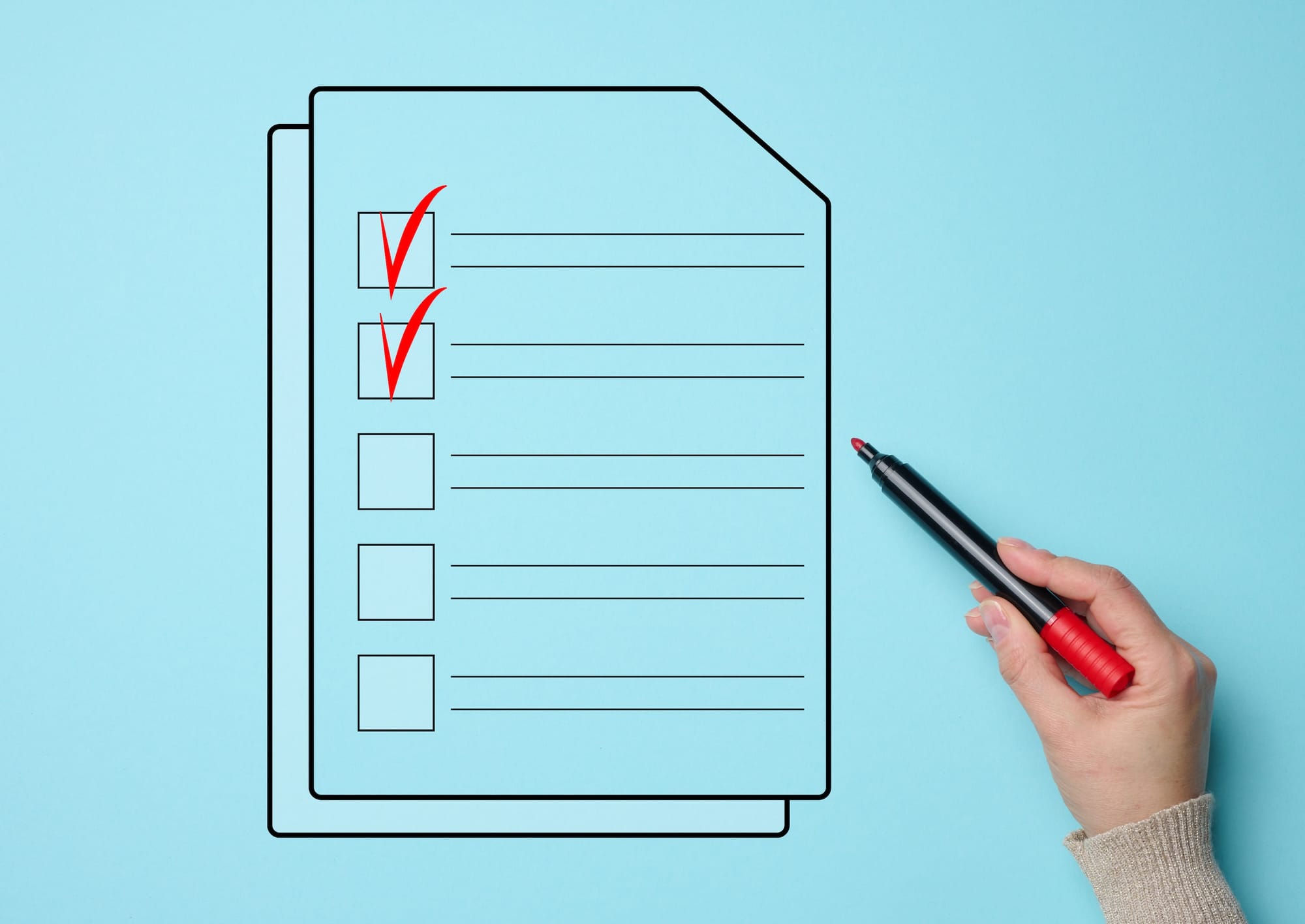 A person's hand holding a red marker, pointing toward a black and white checklist illustration on a light blue background. Two boxes are already ticked with red checkmarks.