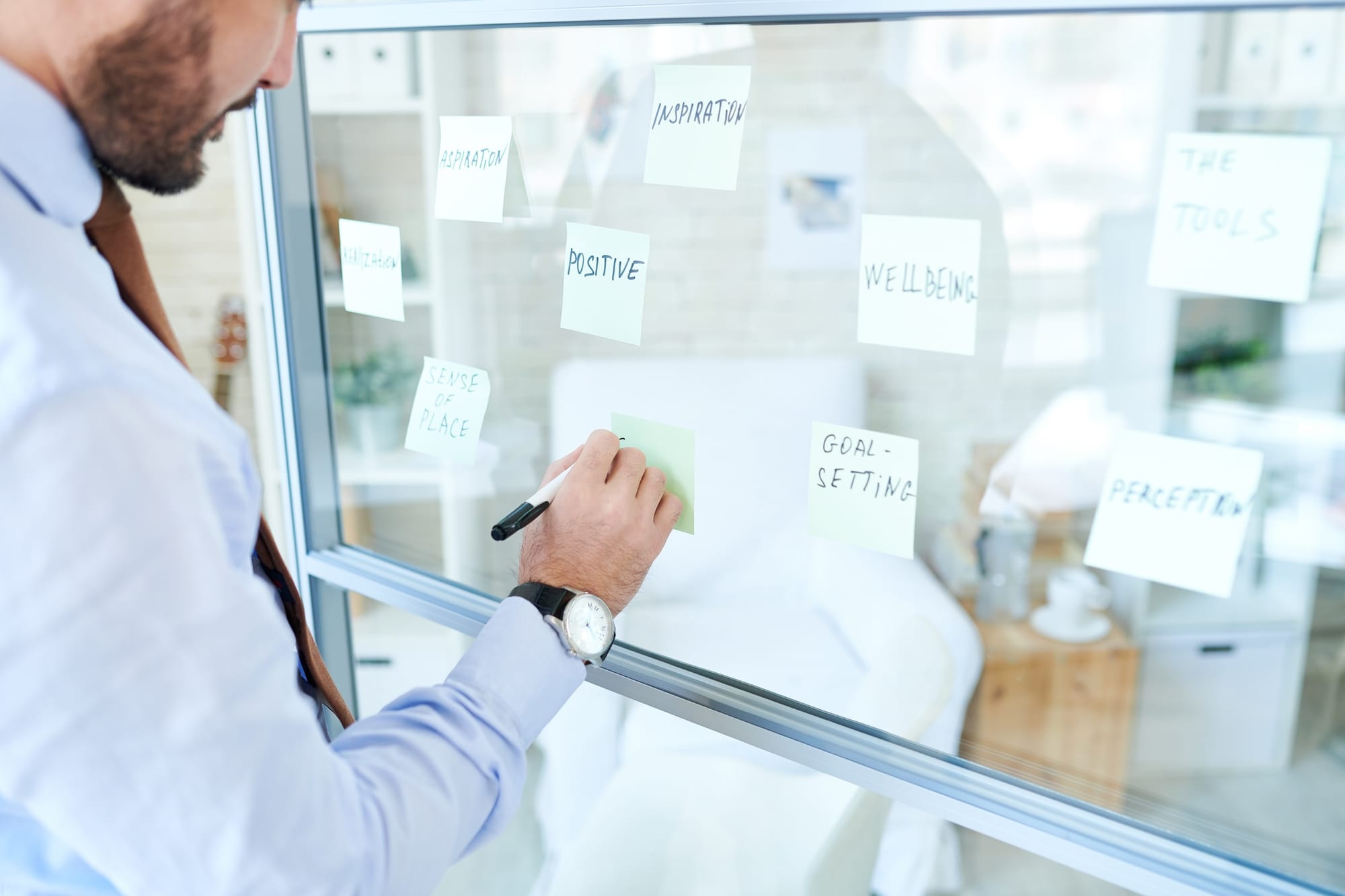 Man arranging brainstorming notes