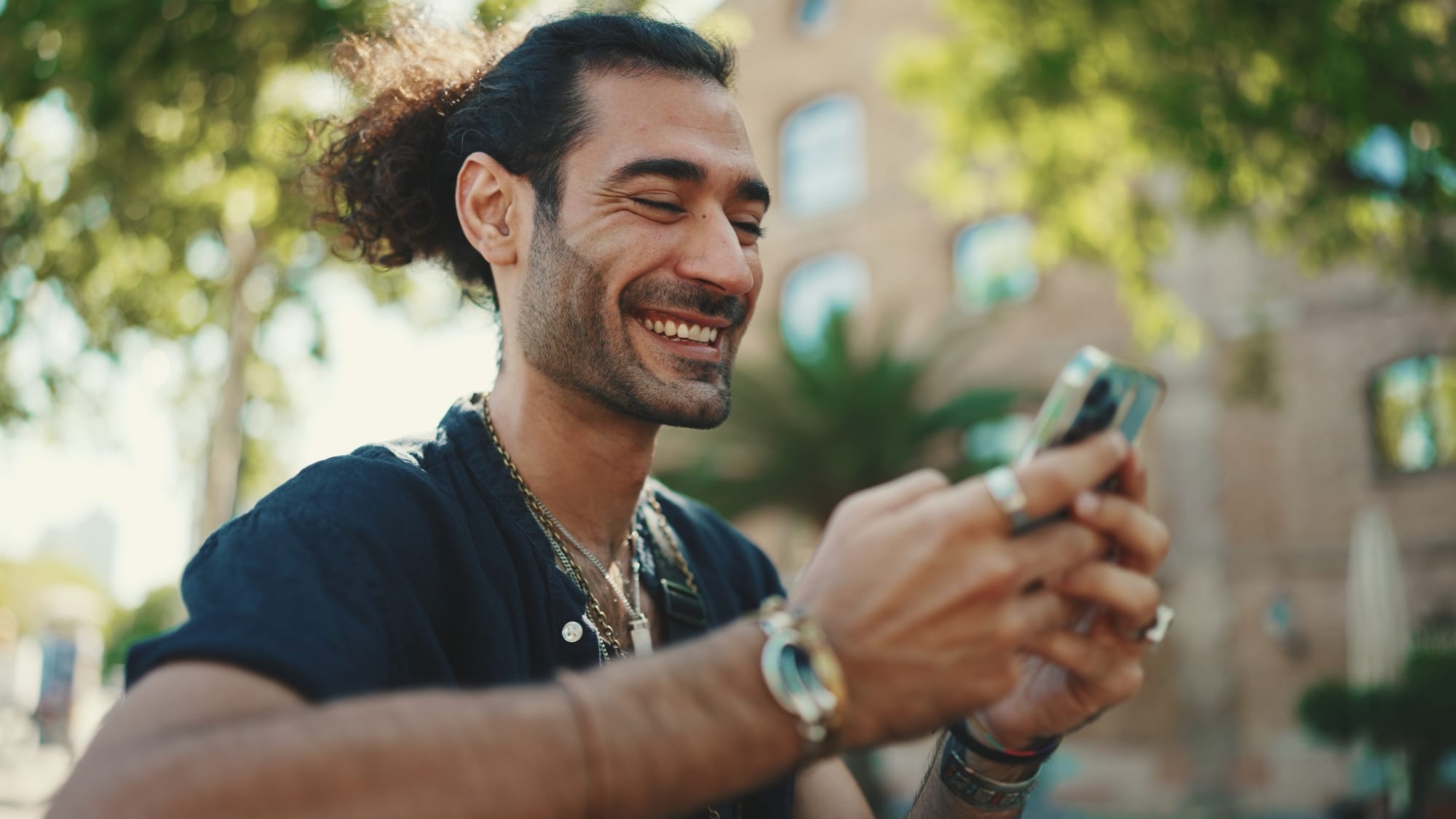 Person looking happily at their phone.