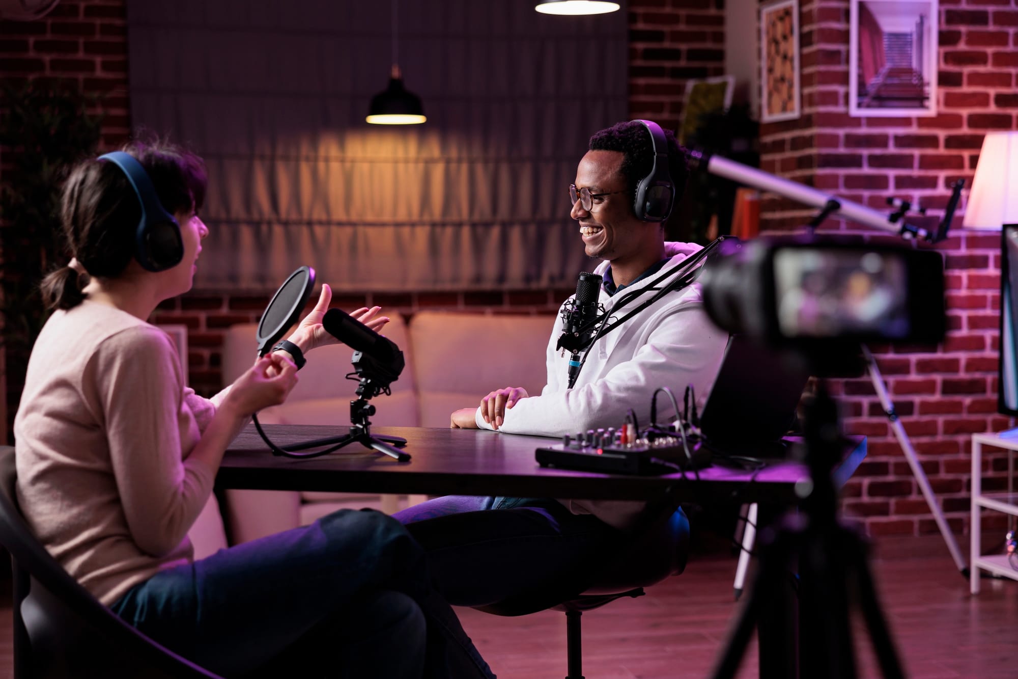 Two people filming video podcast