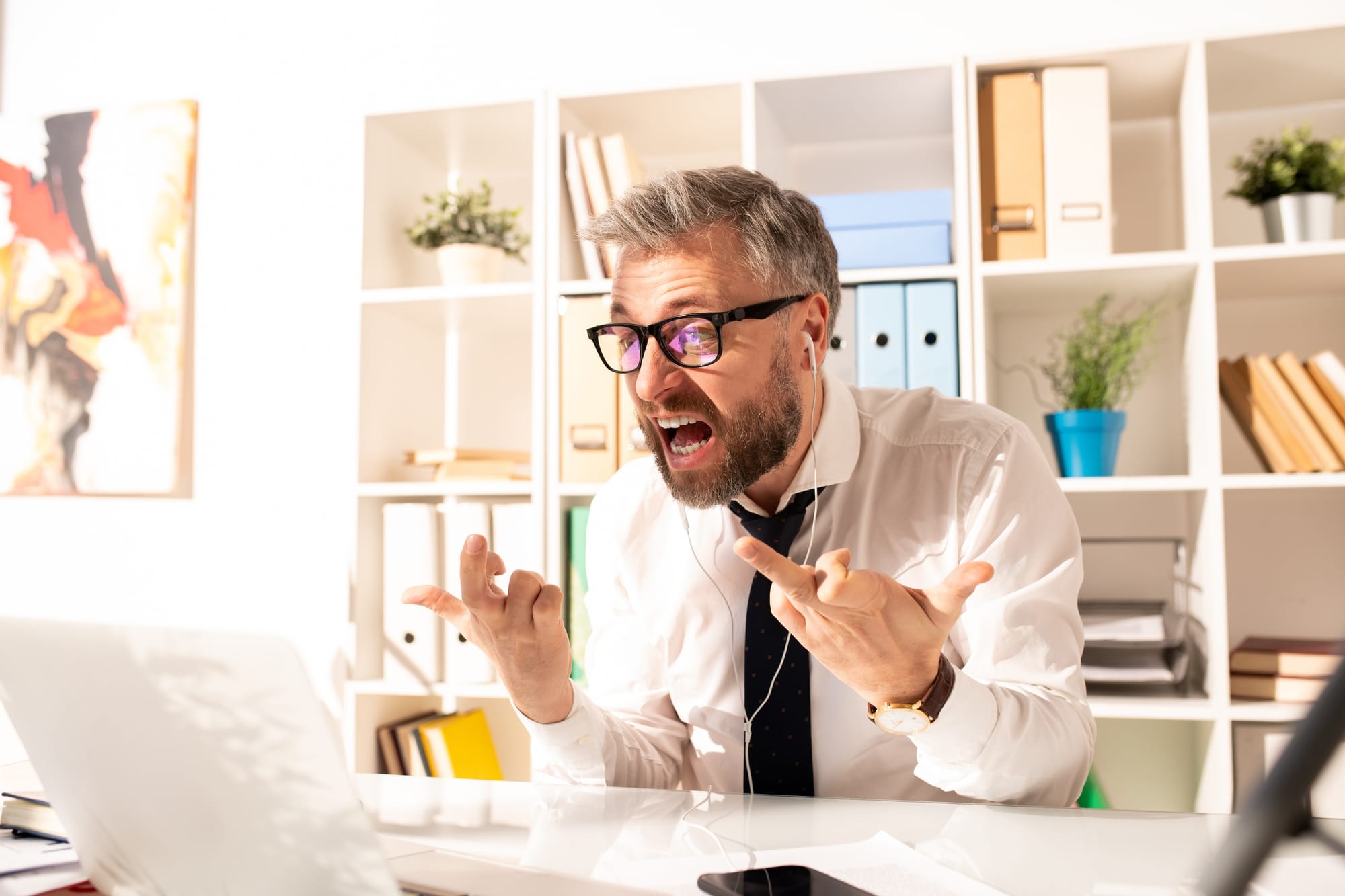Annoyed man shouting at his laptop