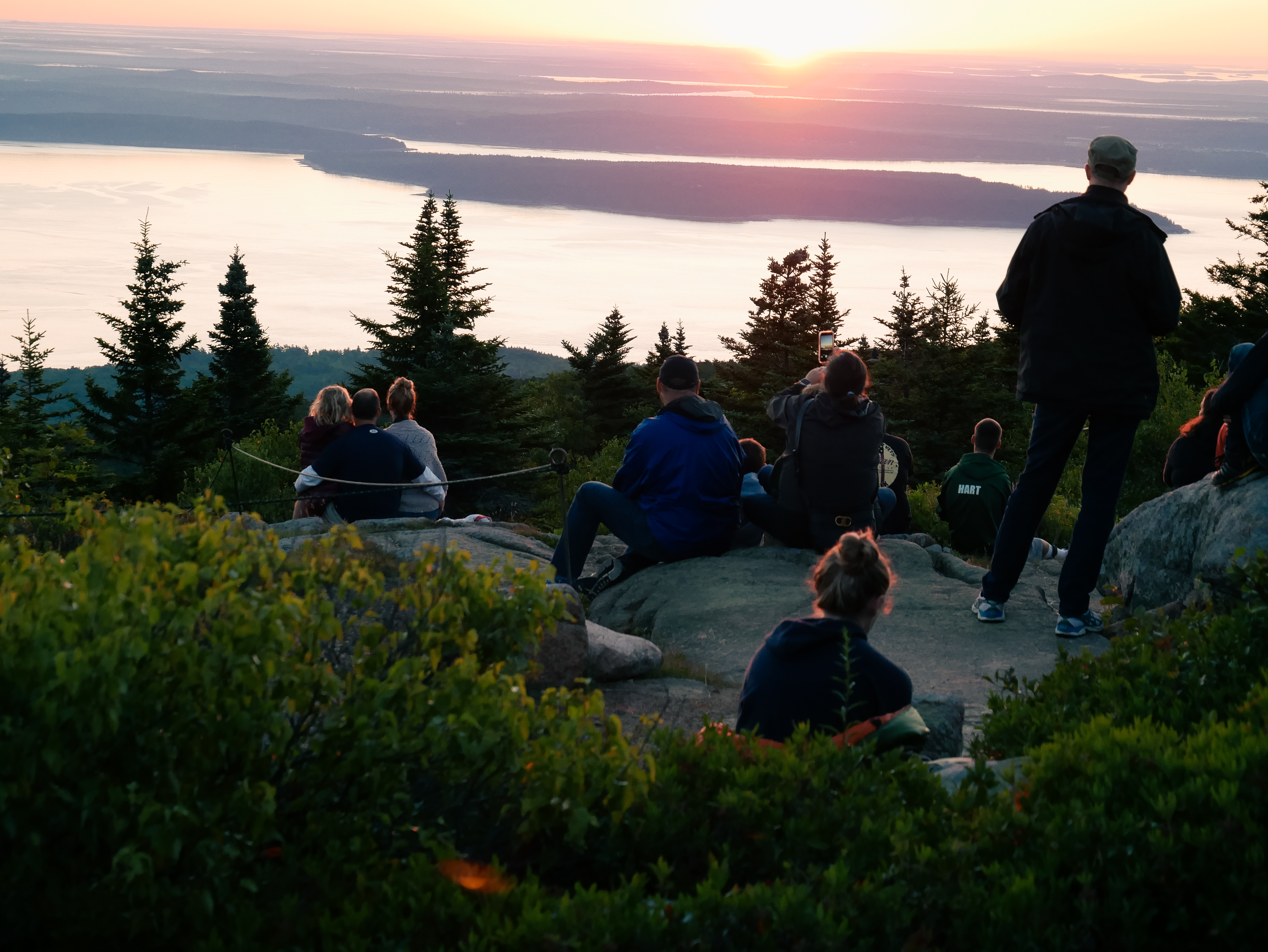 Sitting on the granite rocks of Cadillac Mountain in quiet peace as we watch the sunrise.